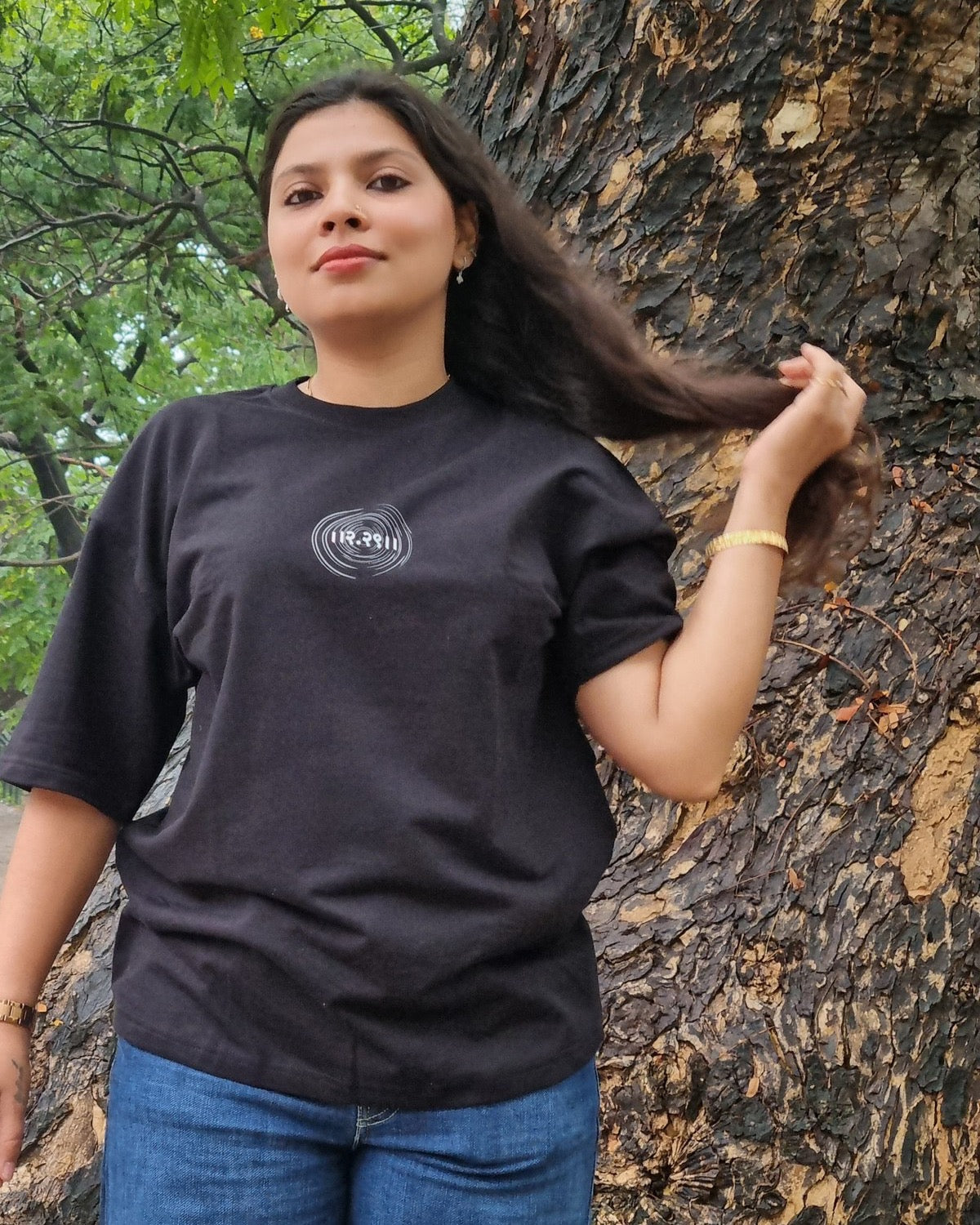 The Ashtanga Yoga T-shirt in Raven Black, worn outdoors, close front view