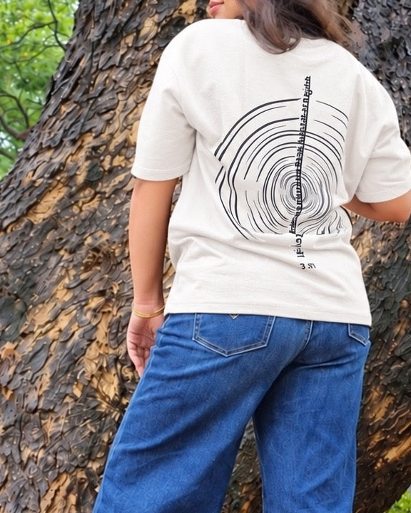 The Ashtanga Yoga T-shirt in Chalk White, worn outdoors, tightly cropped back view