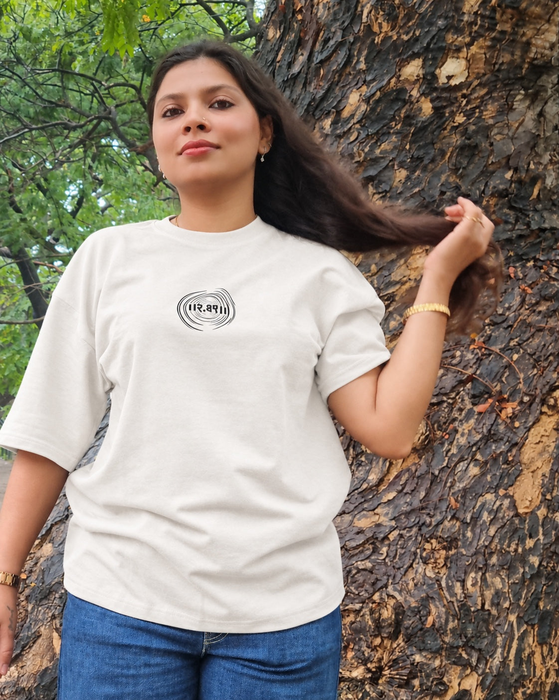 The Ashtanga Yoga T-shirt in Chalk White, worn outdoors, close front view