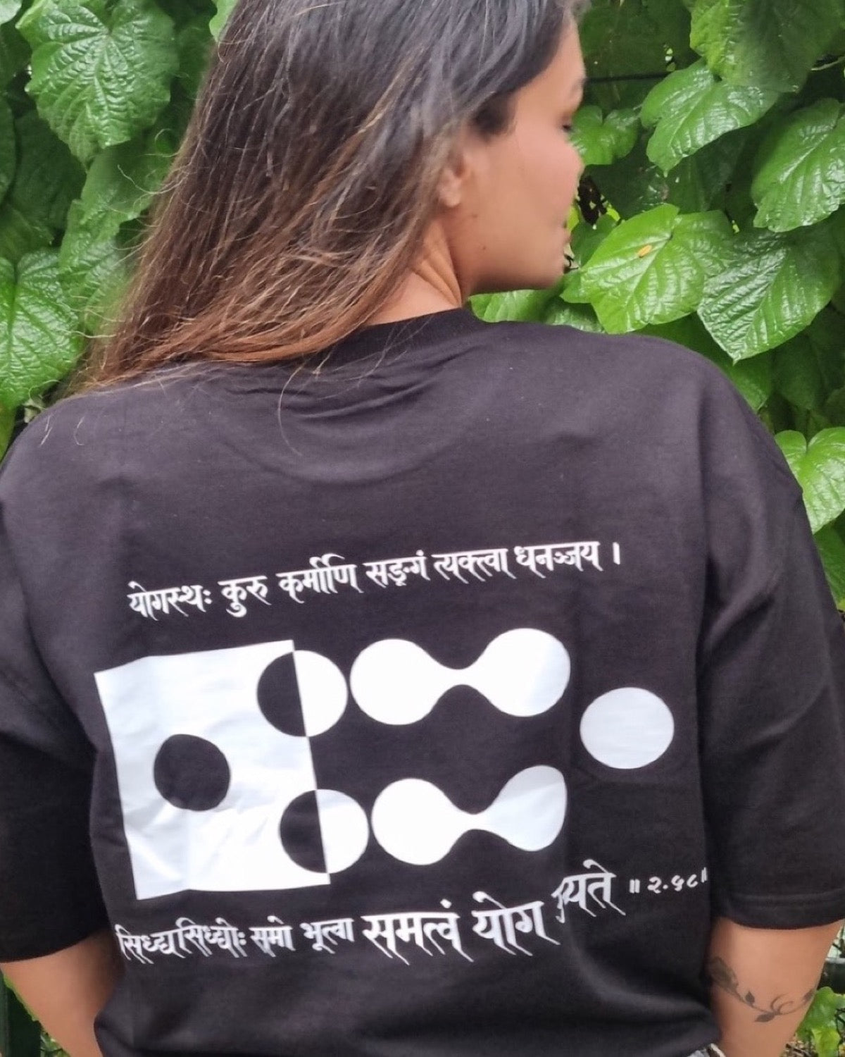 Motivation Unlimited Raven Black T-shirt worn outdoors, print-focused editorial back view