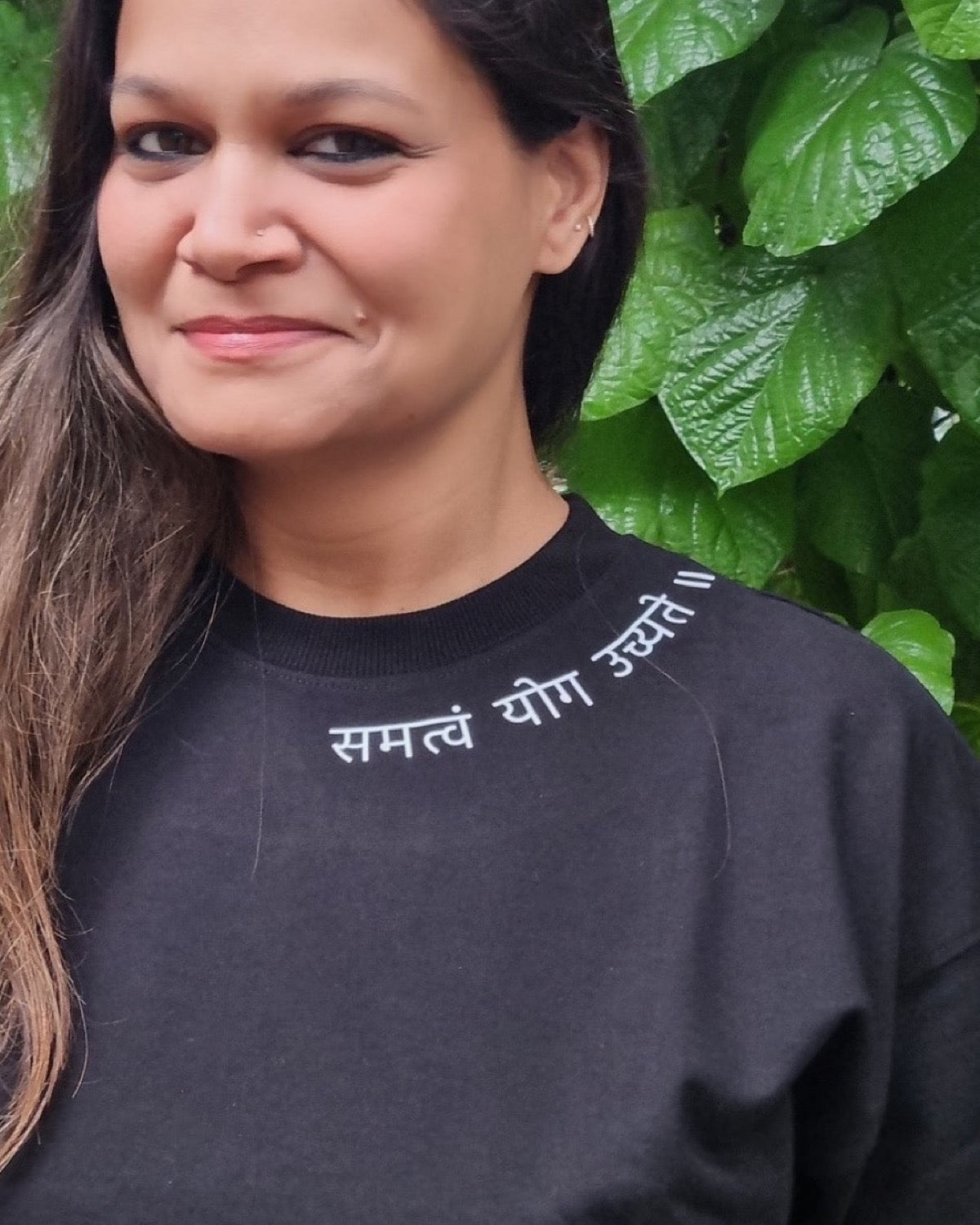 Motivation Unlimited Raven Black T-shirt worn outdoors, print-focused editorial front view