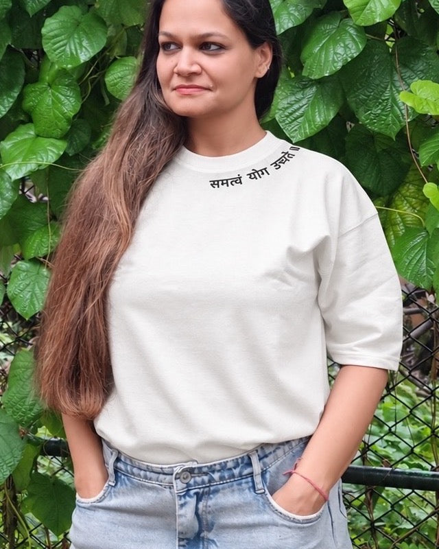 Motivation Unlimited Chalk White T-shirt worn outdoors, print-focused editorial front view
