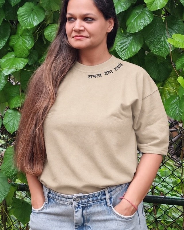 Motivation Unlimited Sandy Beige T-shirt worn outdoors, print-focused editorial front view